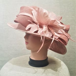 Bow and feather detail of formal light pink dress hat