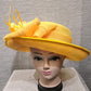 Front view of Formal dress hat in yellow with bow and feathers
