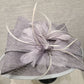 Detailed view of bow and feathers on grey formal dress hat