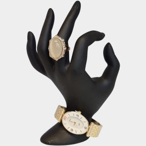 Gold bangle watch with white oval shaped dial