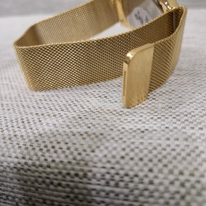 Magnetic closure on gold wristwatch