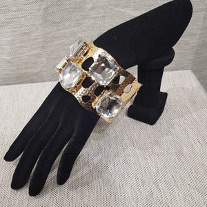 Gold cuff bracelet with large square stones