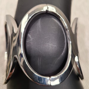 Detailed view of silver color wide cuff bracelet