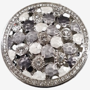 Disc shaped brooch in varying shades of grey and silver