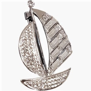 Ship shaped brooch in silver colored frame