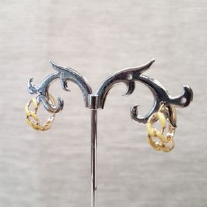 Side view of yellow enameled chain link design hoop earrings