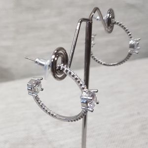 Modern open hoop earrings in silver color frame 