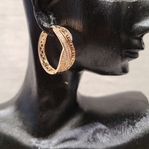 Medium sized gold hoop earrings with clear stones