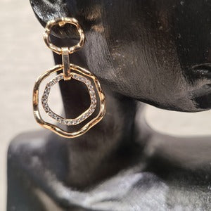 Detailed view of Concentric loop dangle earrings in gold frame