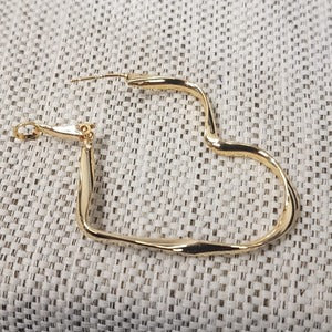 Another view of Heart shaped hoop earrings in gold color