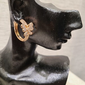 Detailed side view of Hoop earrings with stone studded butterfly detail