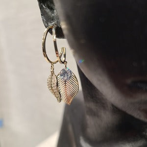 Detailed front view of hoop earrings with dangling leaf detail