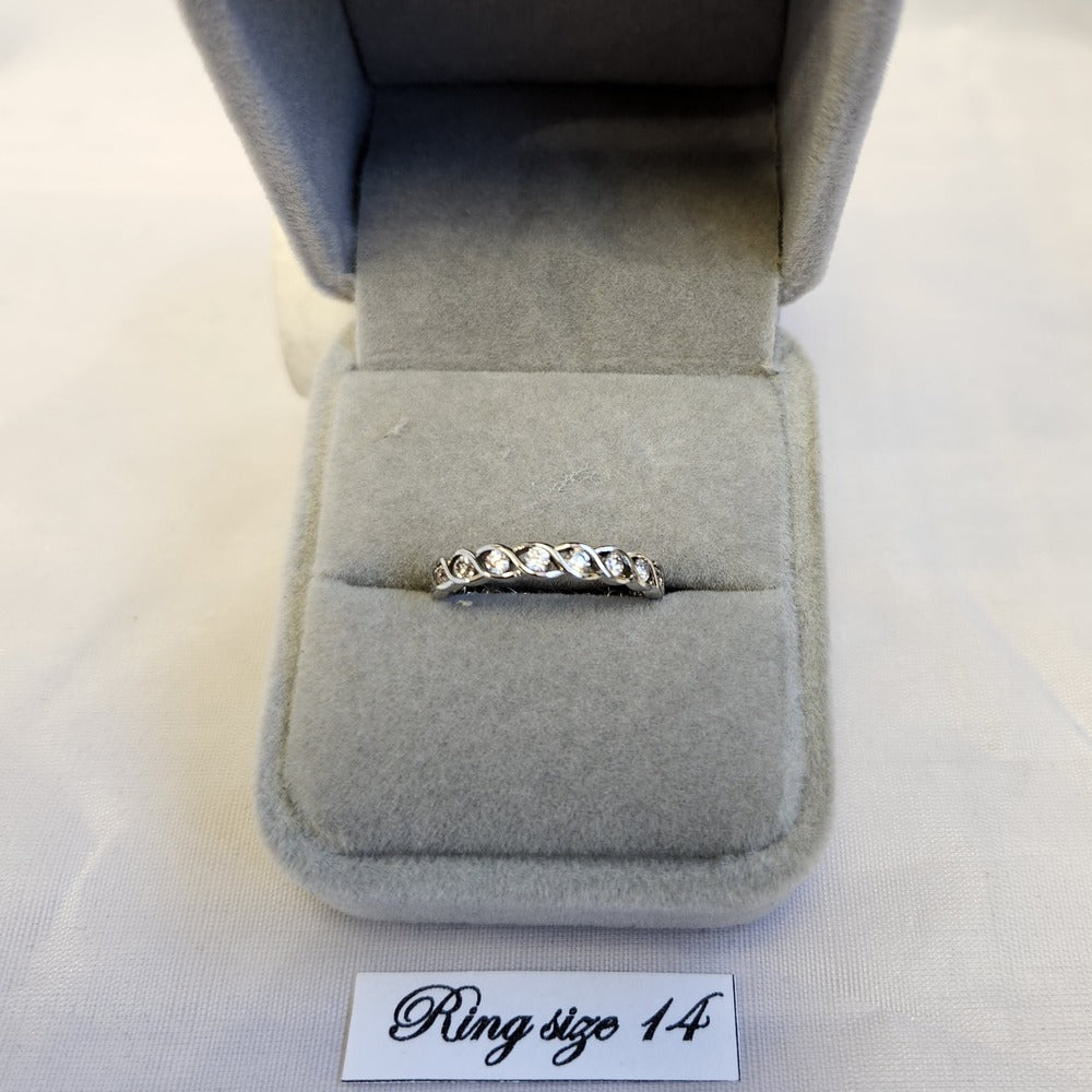 Silver color ring in form of band with clear stone setting
