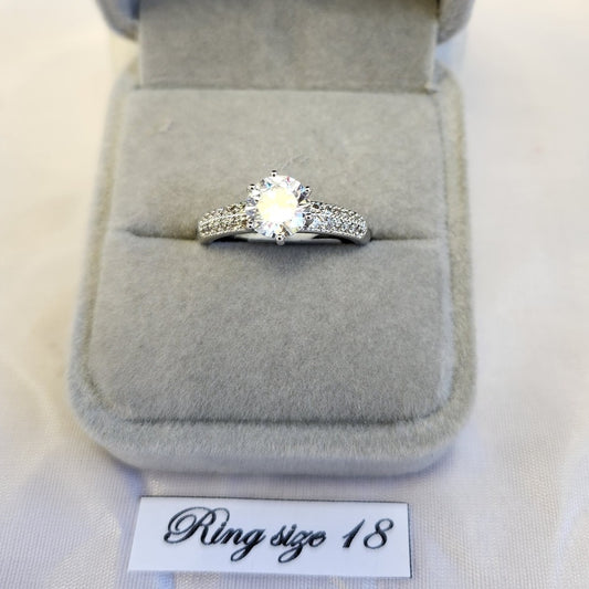 Solitare style ring with stone studded band