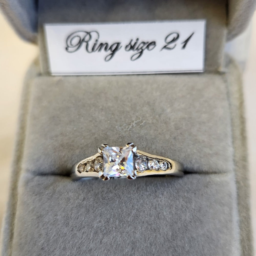 Detailed view of Princess shape ring with stone studded shoulder