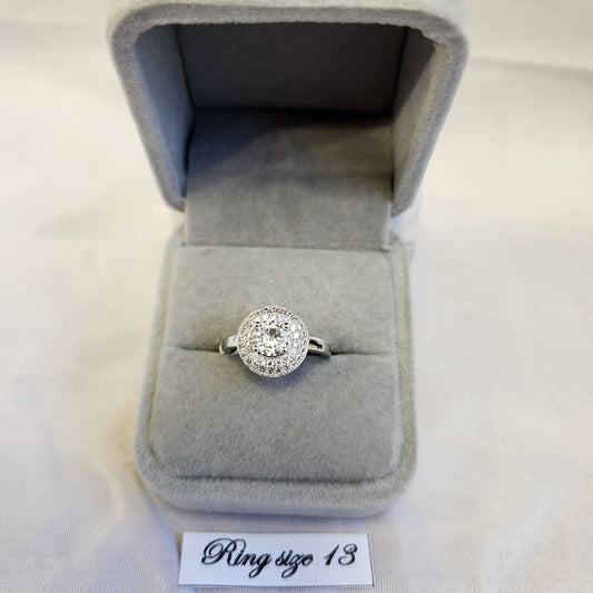 Stunning double halo ring centered around round clear stone