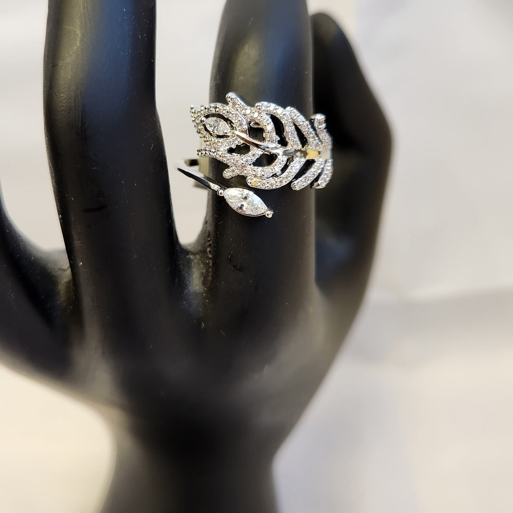Detailed view on mannequin stand of nature inspired feather shaped ring