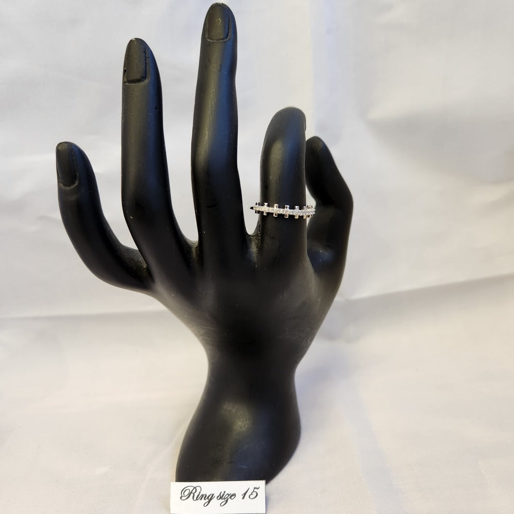 Delicate silver colored stone studded ring displayed on mannequin stand