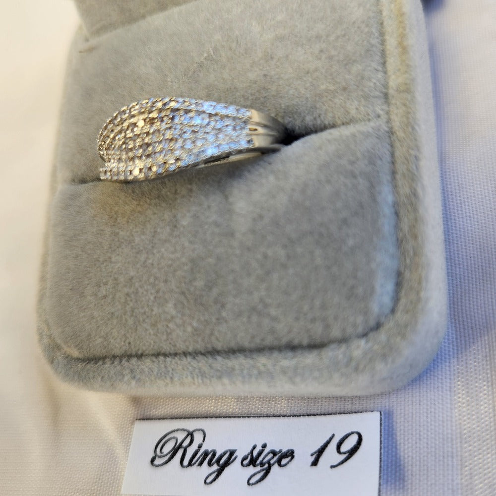 Detailed view of six row stone set silver colored ring
