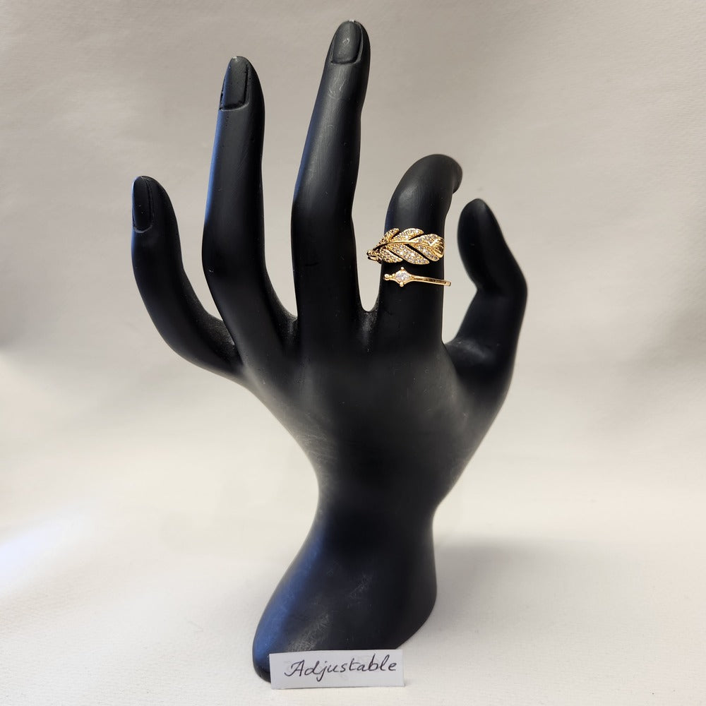 Nature inspired adjustable feather shaped ring displayed on a mannequin stand