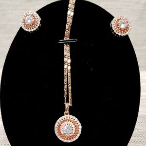 Detailed view of pendant with chain and earrings of jewelry set 