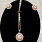 Detailed view of pendant with chain and earrings of jewelry set 