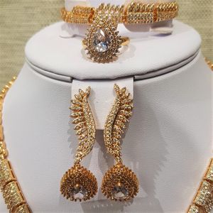 Detailed view of earrings, ring and bracelet of gold jewelry set