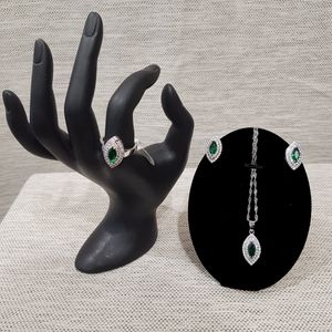 Four piece jewelry set with clear and green stones