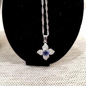 Necklace of four piece jewelry set with clear and blue stones