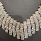 Detailed front view of clear stone embellished necklace