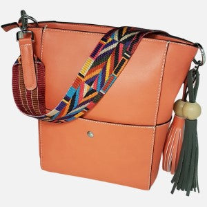 Orange artificial leather handbag with patterned colorful strap.