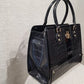 Side view black patent handbag in croc. skin texture
