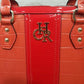 Gold color logo and hardware of  coral red handbag