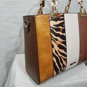 Side view of Fashion handbag with colorful panels and brown wallet 