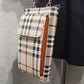 Detailed view of small plaid pattern side bag