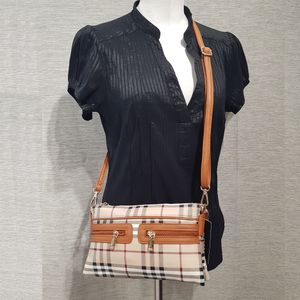 Plaid pattern side bag with tan trim and strap