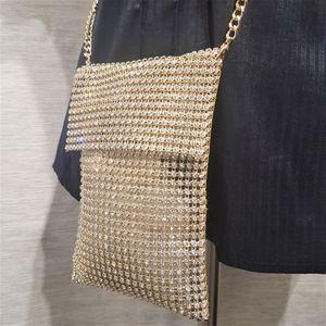 Detailed view of small gold side bag with stones