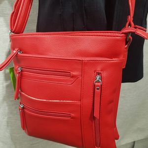 Detailed view of red multiple compartment side bag