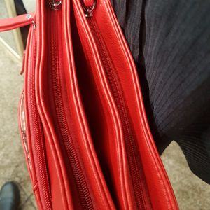 Zipper compartments of red side bag