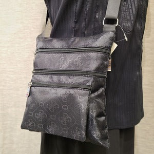 Closer front view of Black self print side bag