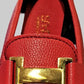 Detailed view of red loafer's top buckle