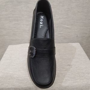 Front view of black shoes with small platform heel