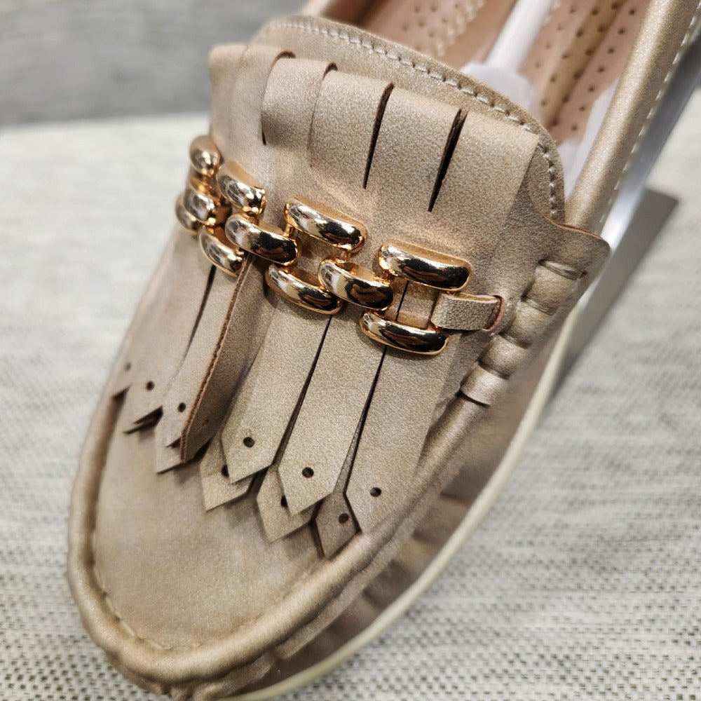 Detailed view of front of light gold flat shoes