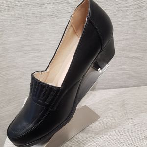 Side view of black pumps with padded sole