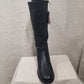 Front view of Black color winter boots for women with side zipper