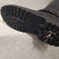 View of flip down spike on the heel of winter shoes