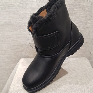 Side view of winter boots with fur lining and velcro closure