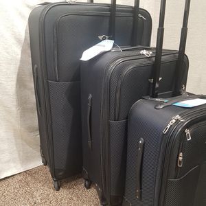 Side view of three piece luggage set in black