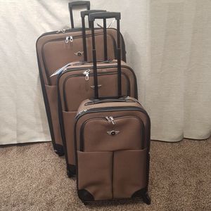 Brown three piece expandable four wheeler luggage set