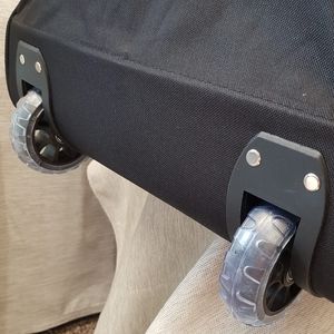 Detailed view of the two wheels under black travel bag